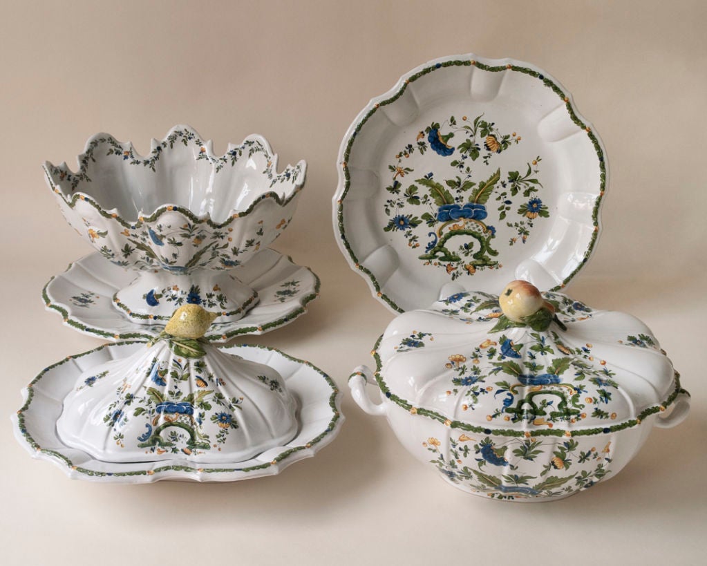 A large and unusual Nove di Bassano decorated faience dinner set, various serving dishes and tureens, 12 coffee and tea services, 24 dinner plates, 12 soup plates, 12 desert plates, 21 serving pieces, 2 candlesticks