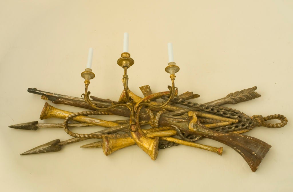 A pair of carved trophy 3 arm sconces