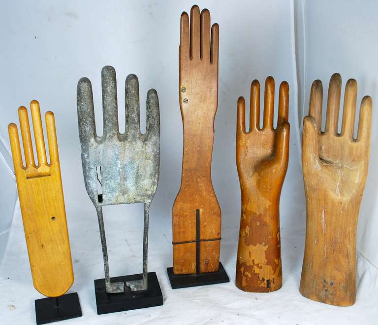 Fun collection of vintage glove molds on stands.