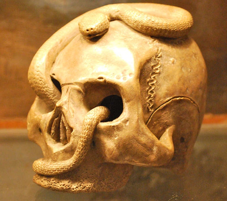 Likely 19th Century.  Ceramic modeled skull with entwined snakes.