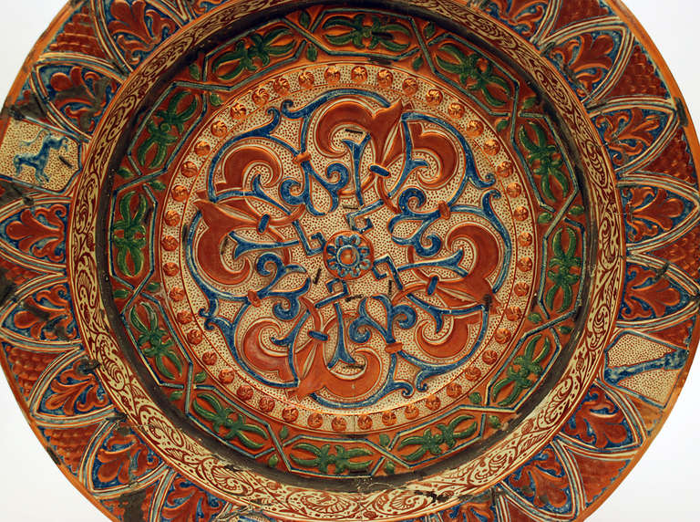 A monumental 19th Century Hispano Moresque Lusterware charger of enormous proportion. Original copper luster glaze with with early Moorish geometric patterns surrounded by multiple rings of green luster. The raised borders with 'Castilla y Leon'