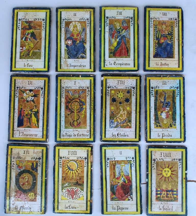 Fantastic collection of French tarot card tiles. These are very large and each one has a custom mount for the wall. Each one depicts a different tarot card. They show great age on both the from and back side. The date circa 1820-1850.