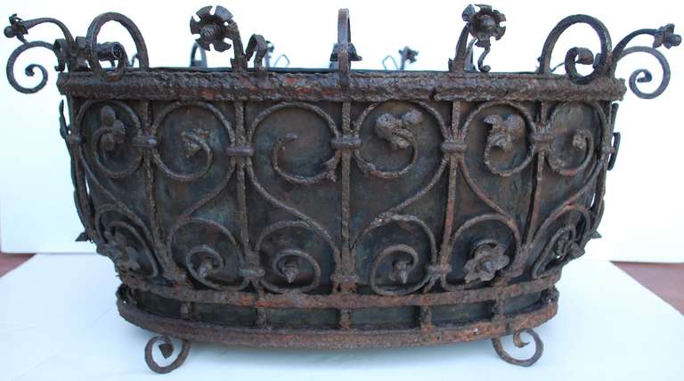 Beautiful garden vessel with zone interior and iron work throughout. Beautiful patina.