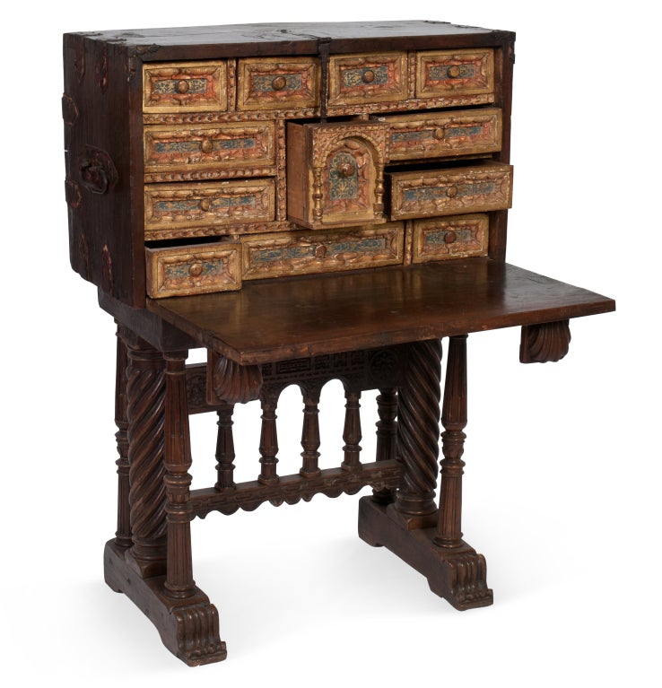 Beautiful 17th Century Spanish Vargueno on stand. Polychrome decorative elements throughout drawers. Original iron throughout. Seashell retractable arms hold drop front.