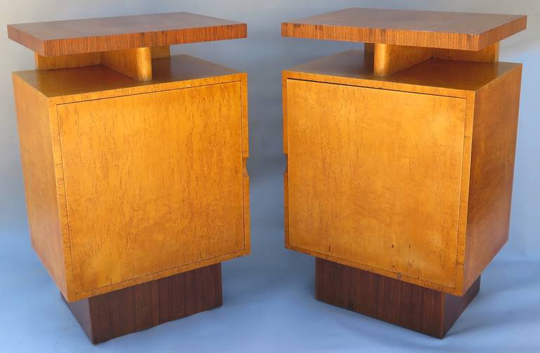 Extremely rare set of side cabinets from Andrew Szoeke, circa 1940. Made from Macassar ebony and bird's-eye maple, they feature a floating top and pedestal base. A single door opens to reveal adjustable shelving on the interior. The quality and