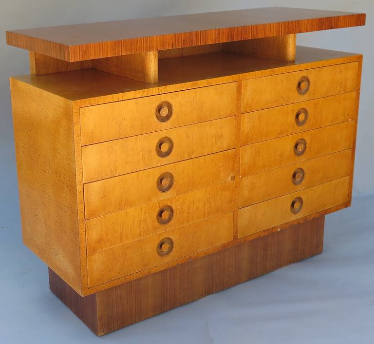 Extremely rare dresser from Andrew Szoeke, circa 1940. Made from Macassar ebony and bird's-eye maple, tit features a floating top and pedestal base. Ten drawers for storage. This piece is of exceptional quality and stunning in person. This is part
