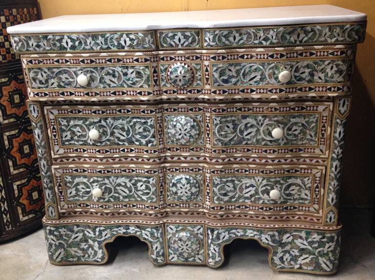 Gorgeous pair of Abalone, and Mother of Pearl inlay dressers from Syria. Marble top with three drawers. Perfect condition.