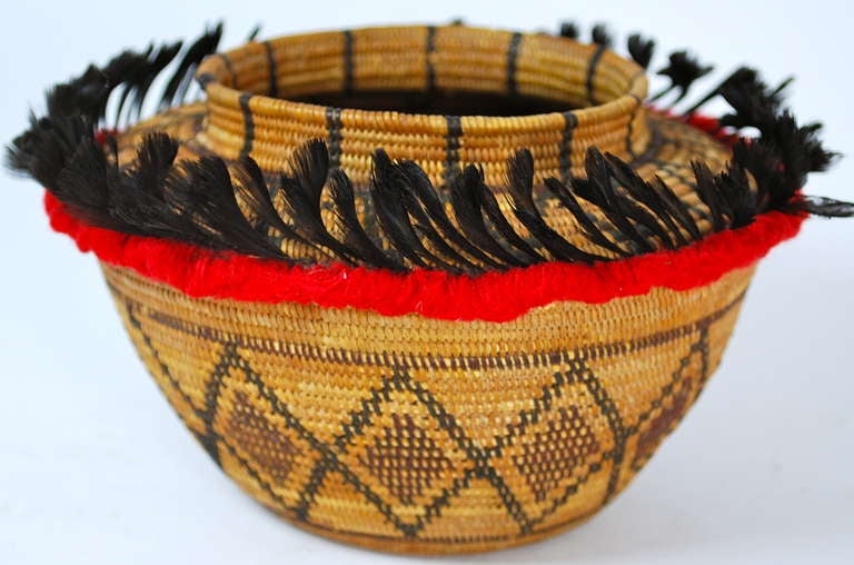Stunning Tubatulabul basket from Eastern California. Late 19th Century, woven of deer grass, willow, bracken fern root and redbud. with red yarn and quail topknot decoration in excellent condition.  Acquired by us from an old Santa Barbara