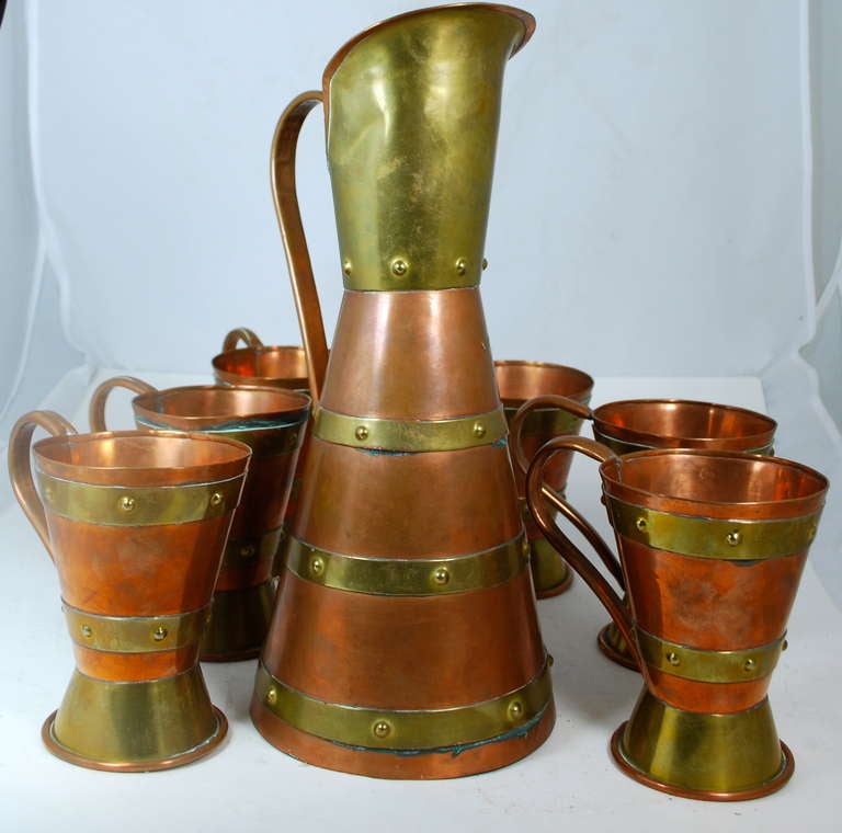 Brass and copper beer set, stamped by Mexican master Hector Aguilar. This set comes with one pitcher and six cups. Every piece is stamped.
Pitcher measures 13"
Cups measure 5".