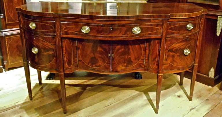 Exquisite New York Federal Period Sideboard

--Bookmatched Crotch Mahogany Veneers and Solid Mahogany
--String Inlay, Tapered Legs, Serpentine Front
--Early Clean Finish
--No Reduction in Height
