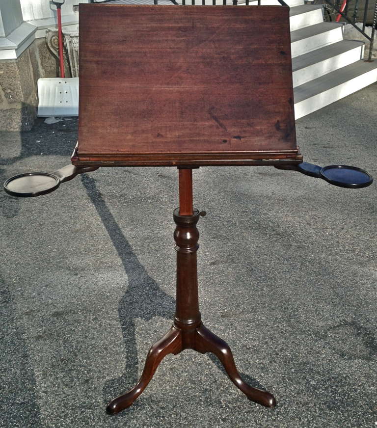 George III Period Walnut Adjustable Reading or Music Stand

--Telescoping for various heights
--Original candlestick holders
--Slipper foot
--Top closes to a flat table