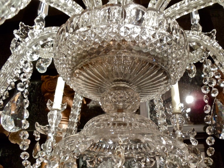 Georgian Style Cut Crystal Chandelier

--Six Candle Arms in Lower Tier, Three Candle Arms and Three Spiked Arms in Upper Tier Issuing from a Georgian Cut Bowl
--Original Round Diamond Cut Crystal Chains and Large Teardrop Shaped Prisms
--Urn