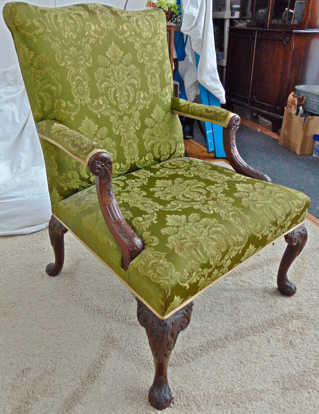 Period George II mahogany armchair in the manner of William Kent.

--Original and well carved details, volutes, fluting and back feet.
--Elegant sloping back.
--Ample to large-scale to be most comfortable in today's standards.
--References:
