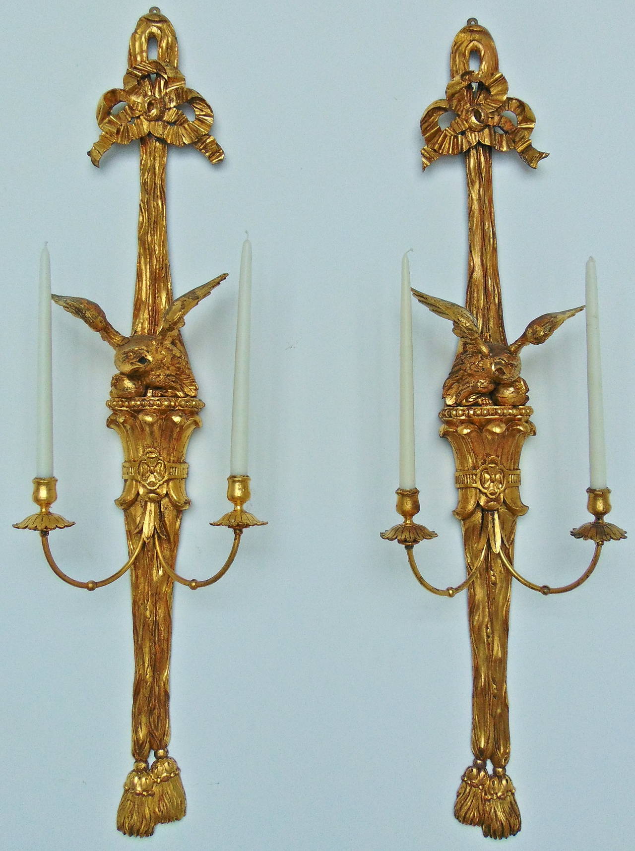 Pair of Georgian or Federal style giltwood eagle sconces.

--Realistically carved two-arm sconces.
--Eagle and fabric swag in neoclassical form.