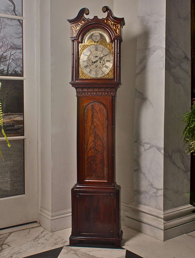 George III Mahogany Long Case or Tall Case Clock

--Architectural Broken Arch Pediment Top of Chippendale Form
--Exquisite Face with Moon Dial and Country Landscape in Rare Grisaille Color
--Full Chime and 8 Day Brass Movement  
--Cleaned and