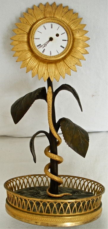 Rare First Empire Sunflower Clock.  Naturalistically Modeled with Serpent Winding Its Way Up the Sunflower Stalk.  Amazing Detailing from the Late 18th Century post Revolution.  A True Masterpiece of Patinated Bronze and Ormolu of 