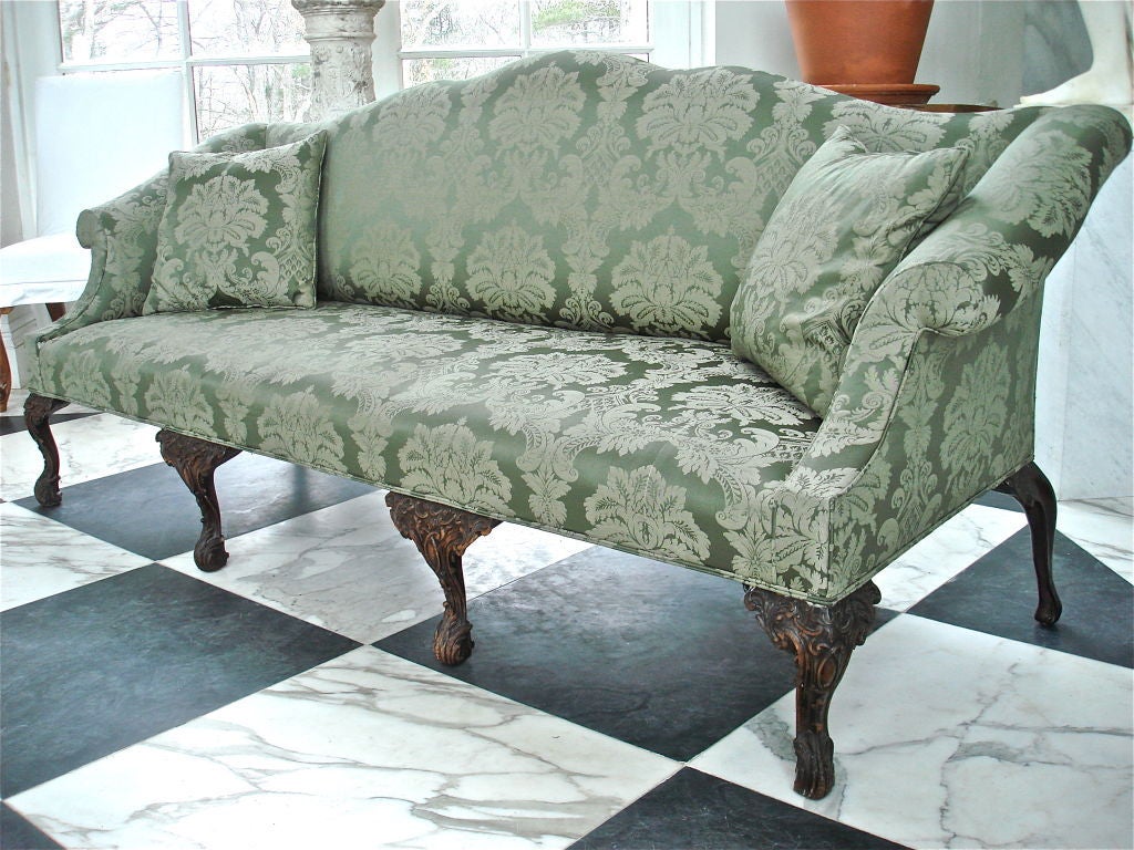 Irish Walnut Camelback Sofa in Georgian Chippendale Styling.  Carved Legs, triple camelback.