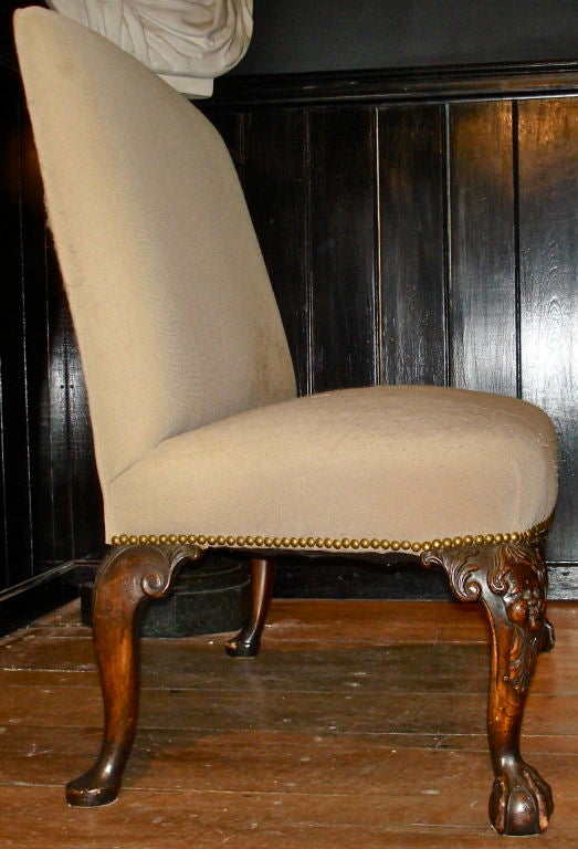 Nineteenth Century Irish Georgian Style Settee.  Armless Banquette with George II Style Walnut Legs.  Front Legs Carved with Face