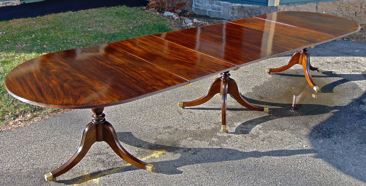 Solid mahogany three pedestal dining table.

Rare narrow width.
Very good wood selection.

Two 18