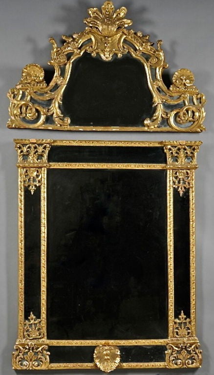 Carved and Giltwood French Regence Mirror.  Exquisitely Carved and Designed with Architectural and Stylized Columns, Shells and Festoons.  Original and Well Aged Mirror Plates