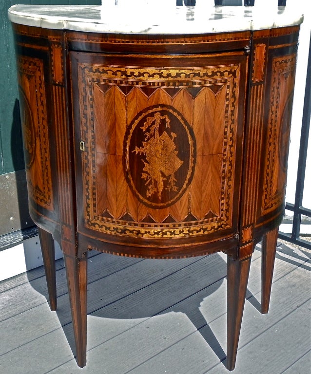 Pair of Italian Neoclassical Demilune or Half Round Commodes.  Satinwood, Rosewood and Tulipwood Inlays and Marquetry

Front Inlaid with Classical Bust and Musical Instruments with Laurel in Oval Cartouche.  Sides Each with Violins and Wind