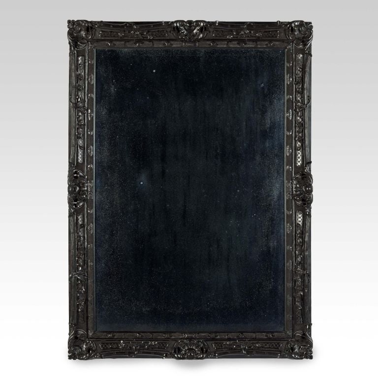 A very unusual mid-19th century Anglo Indian rococo revival ebony pier mirror, each element is finely carved with foliate ornament and “C” & “S” scrolls with carved shells at the corners and the centre of the sides