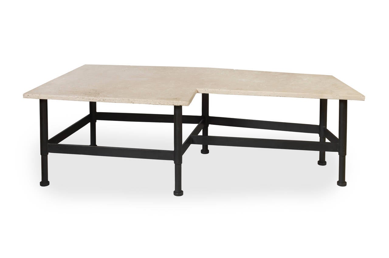 Two asymmetrical travertine and iron tables. Can be used together as a single or as separate coffee tables.

Each table measures 22.5 inches wide.