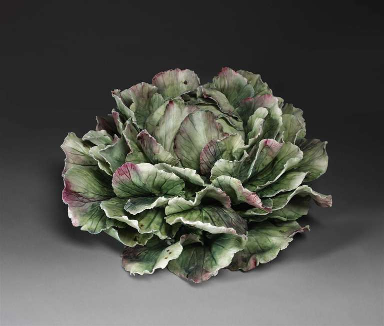 A bisque fired bowl in the shape of a cabbage. With detachable lid.