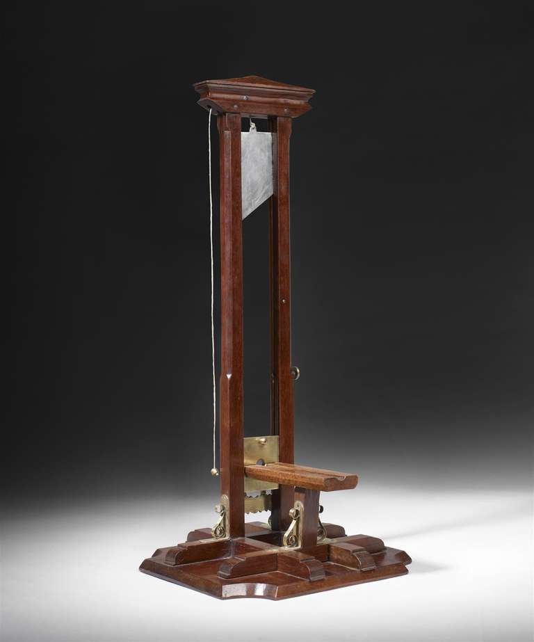 A cigar cutter In the form of a guillotine made of mahogany, brass and steel.

Location: Mallett NY

(O3E0013)