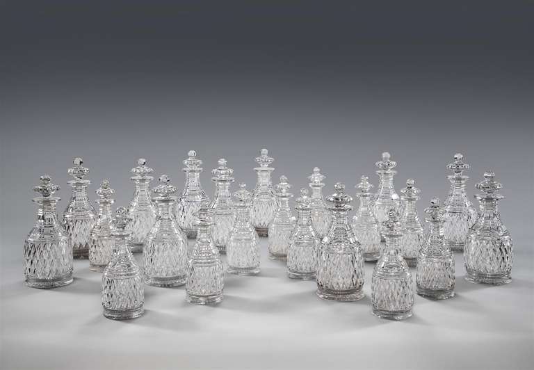 A set of early 19th century cut glass mallet-shaped decanters, decorated with a broad band of cut diamonds below tapering step cut necks, retaining their original stoppers, ten large and eight small.

Continental, circa 1830

 Height:    11.4 in