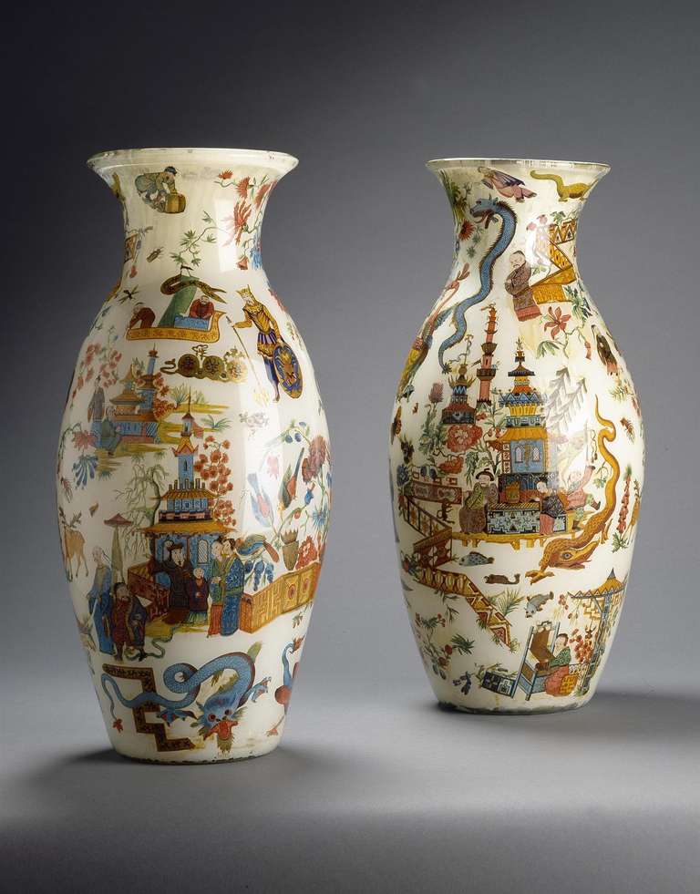 An exceptional pair of 19th century decalcomania vases of large size and in fine condition, profusely decorated on all sides with chinoiseries including groups of figures, pagodas and a variety of exotic beasts, all on a ground of very pale