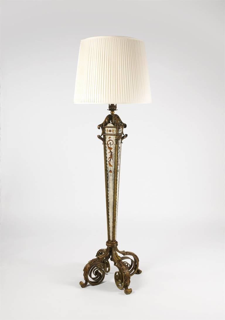 A fine quality parcel-gilt wrought iron floor lamp attributed to Serge Roche, inset with four verre eglomise panels by Robert Pansart, surviving in excellent condition. (L3D0140)