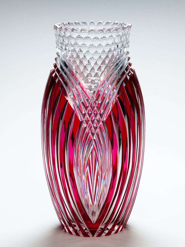 A red over clear ‘Seurat’ vase by Val Saint-Lambert, the bulbous body cut with concentric arcs below an imbricated clear neck and rim.