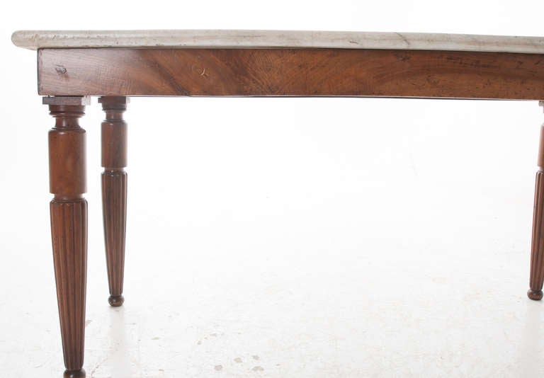 Stunning butchers presentation table with thick, worn original marble. From the early 1800s as marble tops became outlawed to butchers shortly after. Due the the porous nature of the stone, it was unsanitary. The base of this table has a breath