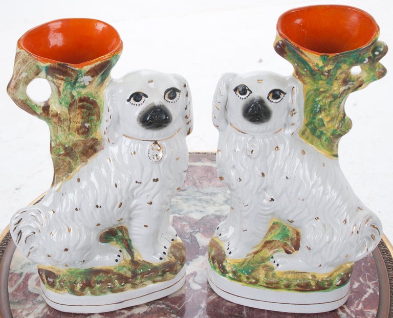 English pair of Victorian Stafford shire pottery white spaniel dog spill vases, molded on their bases and hand painted. Very playful and colorful, love their eye lashes! 
Fore more items similar to this, please visit our extensive website.