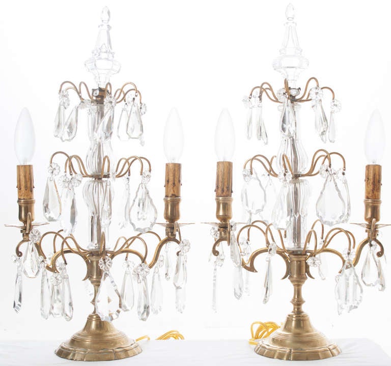 Stunning pair of 2-light candelabra girandoles with clean crystal blown glass sections in the centers, extending to the top. Brass arms hold a lovely collection of clear crystal drops. Now U.S.. electrified