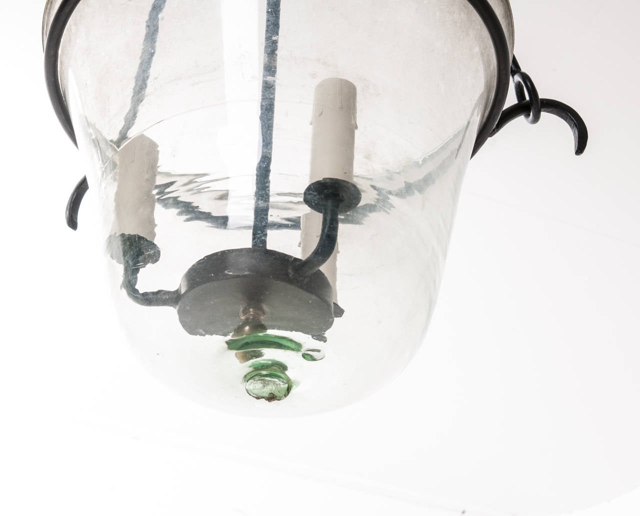 A custom designed hand made iron lantern holds an antique English glass cloche. A cloche was used in the garden to protect plants from frost and force their growth. Very few of these have survived, primarily because they were used outside in the