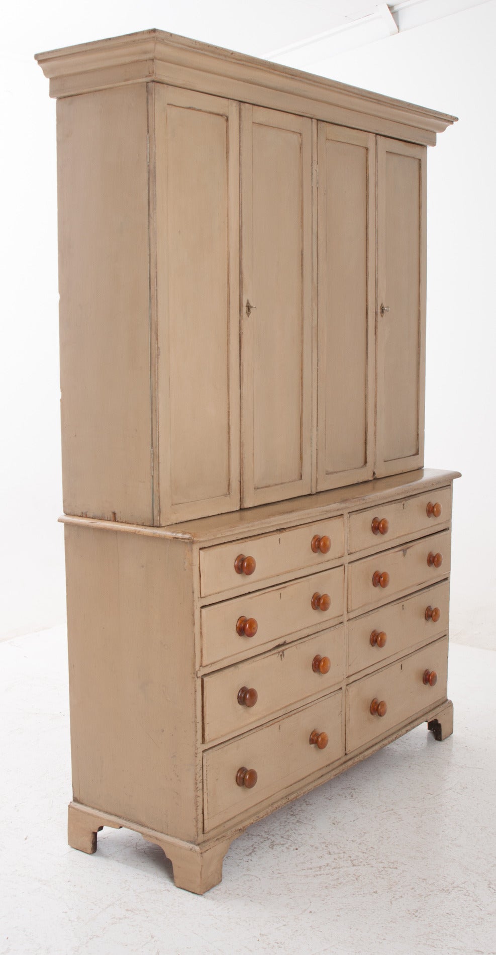 A fabulous painted pine butler's pantry would have felt right at home in Downton Abbey. The yellow paint is original to the piece and has rich patina; the interior of the top cupboard is a beautiful turquoise. Below are eight drawers all with wood