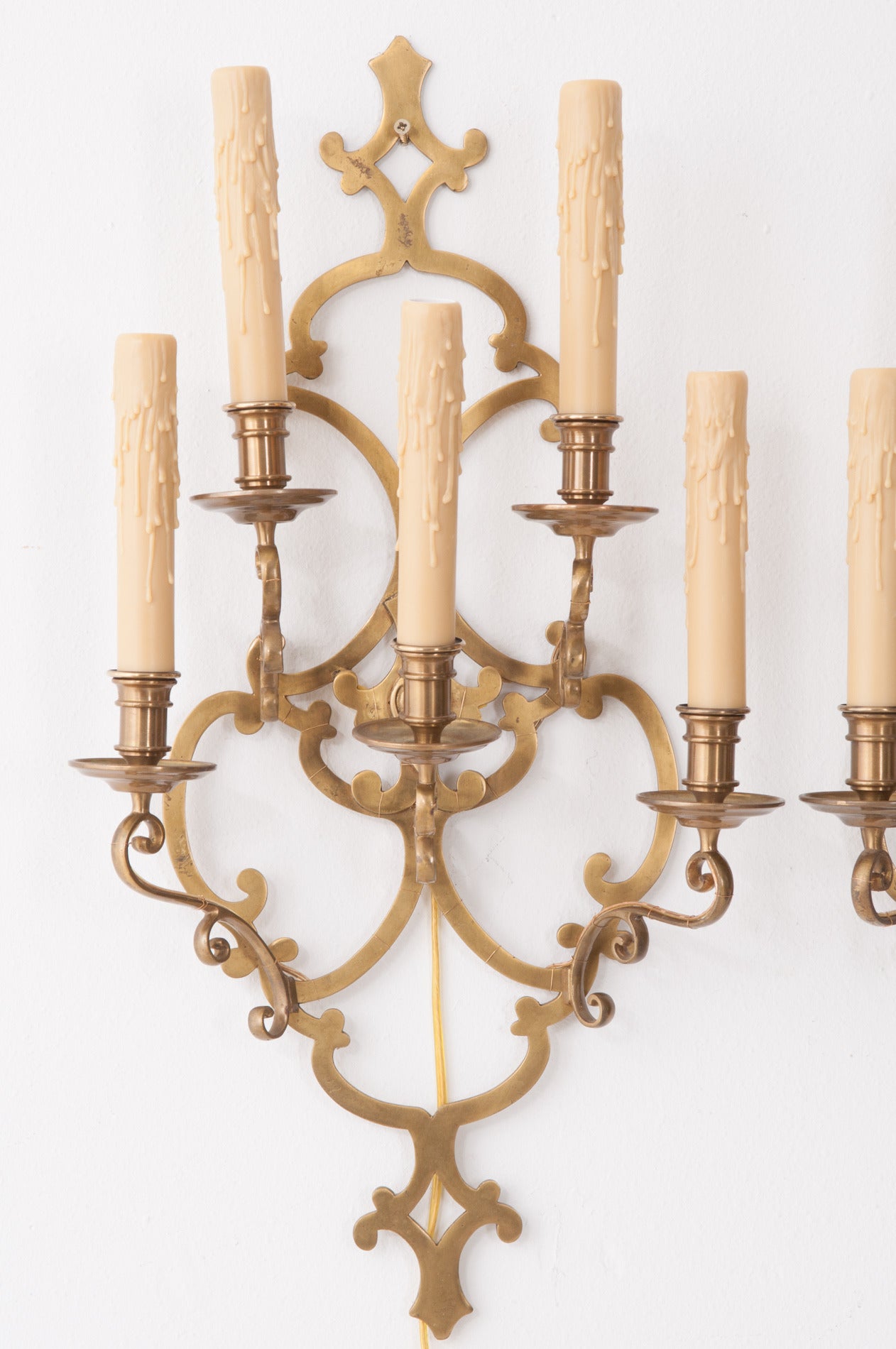 A wonderful pair of French sconces with a playful design, holding five candle cups each is both elegant and efficient. See the detail photos to capture more details. Cleaned and U.S. wired, 1900.