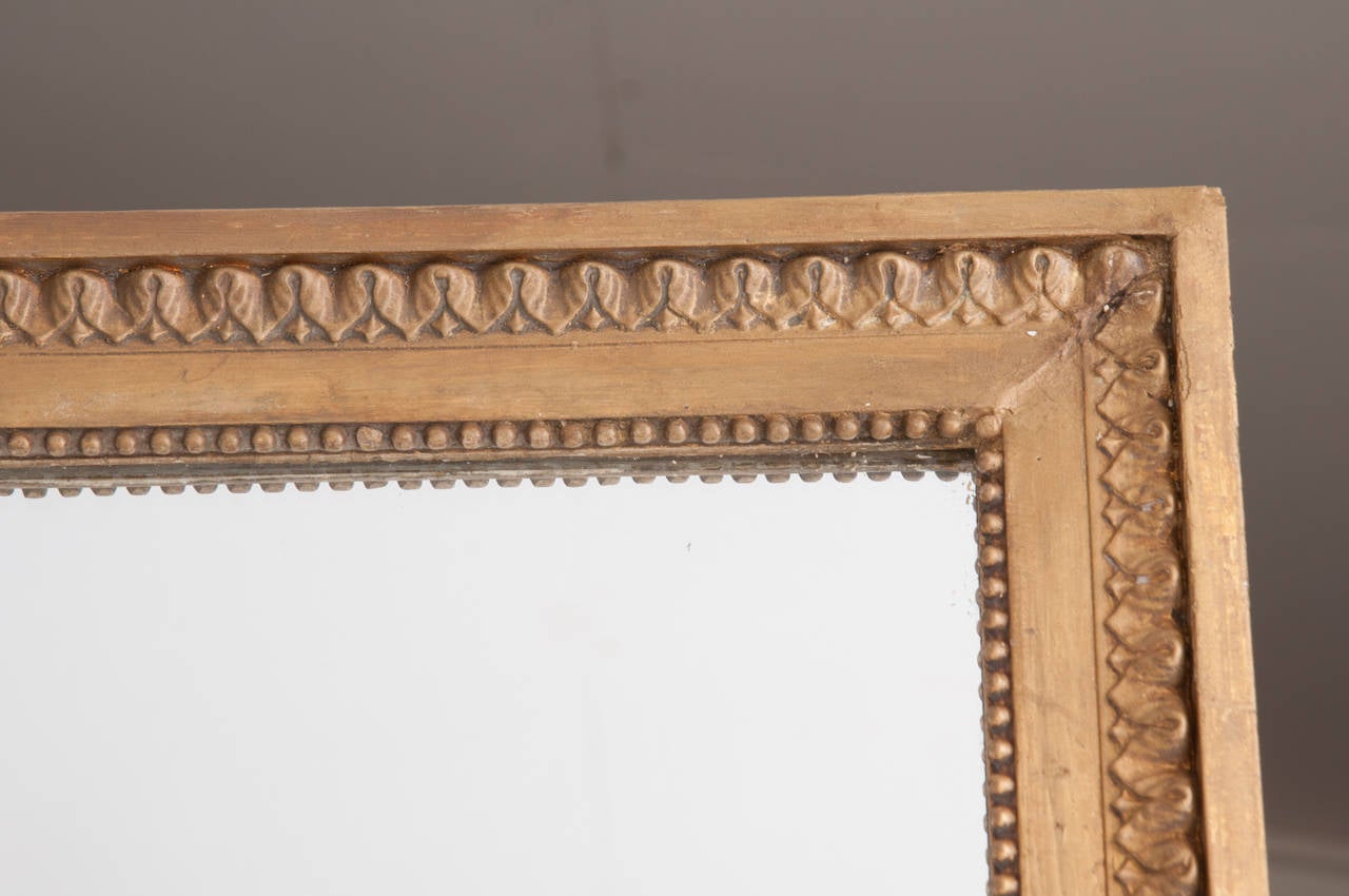 This mirror was taken from a larger collection of boiseries trumeaus and panels. Simply carved and constructed, this mirror is the perfect antique to mix with modern furniture. See the detailed pictures, there was some damage to the frame which has