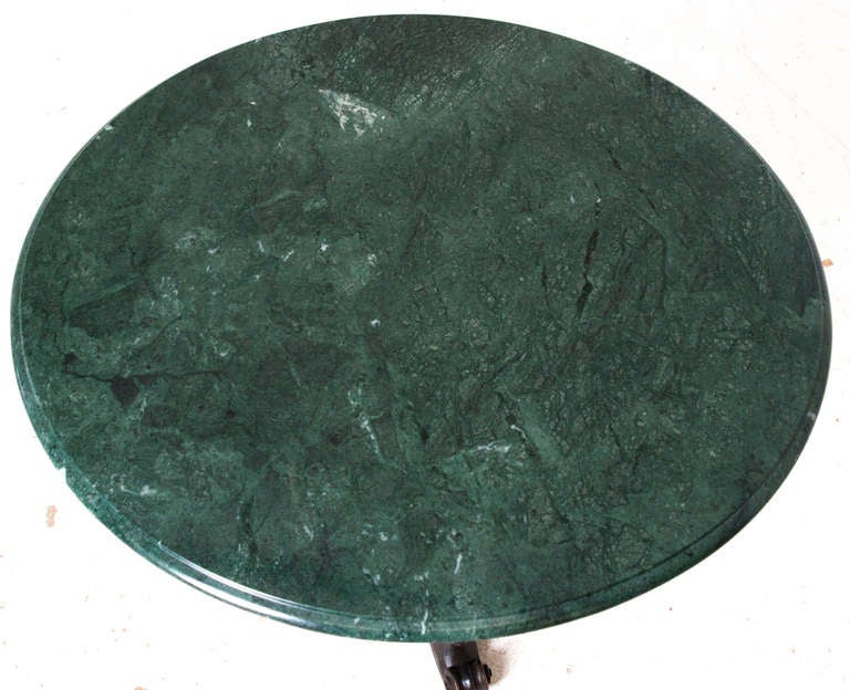 Russian round marble top table. Green marble is more recent and sits over old ebonized wood and carved pedestal table. Beautifully detailed and unique sitting over 3 splayed feet. Very unique with the upside down turned wood finials. c.1880 or