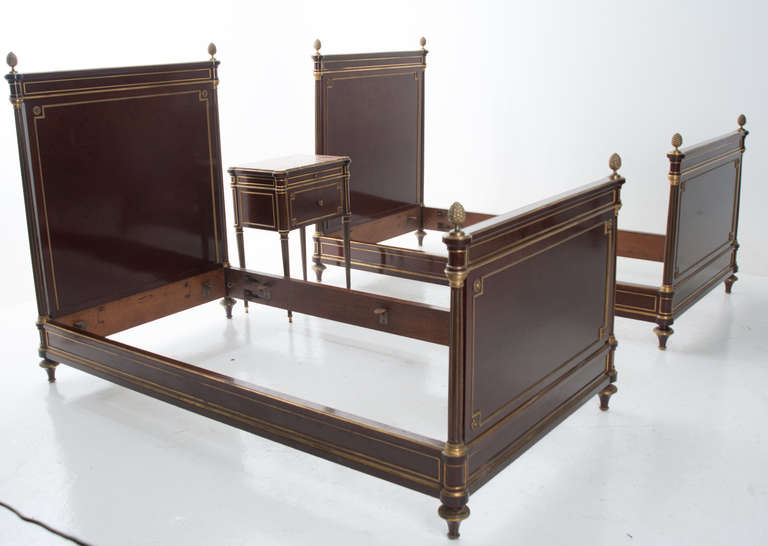 French Henry Dasson (Stamped) Plum Pudding Mahogany and Ormolu Bedroom Suite Two (2) beds, and a marble top nightstand in the Louis XVI style, 1891. With “Henry Dasson” and “1891” stamped inside the lower panel of the headboard. The Nightstand: The