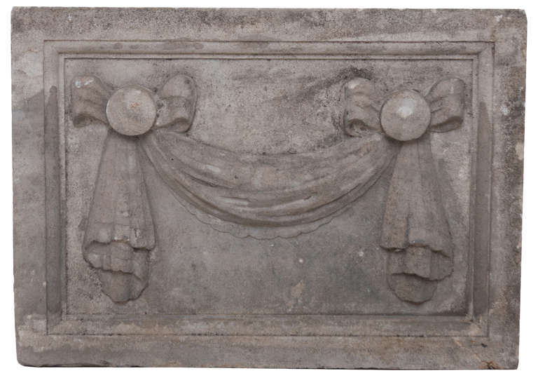 Pair of English carved limestone plaques with simple bows and their swag. Middle 1800s