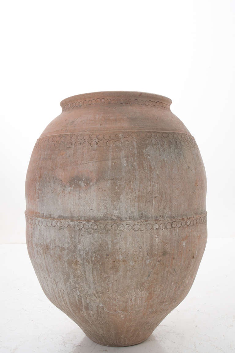A large Spanish olive oil jar made of terra cotta with wonderful detailing and patina, at the base of this fine jar is the oil spicket. Circa 1890s.
