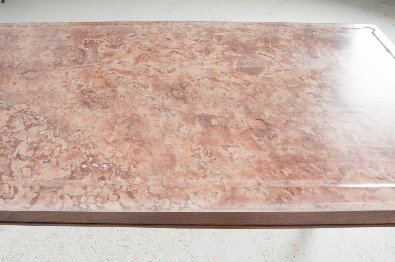 A stunning old hand cut butcher's marble with hand cut indention's down the sides with pools on the corners to catch the juices from the meat! This wonderful old pink marble is the perfect table top. We have built a custom table base in our workshop