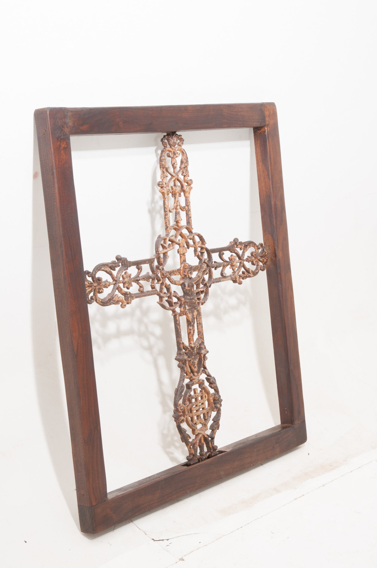 French cast iron cemetery cross with the crucifix in the center has its original old paint finish. We built a custom walnut frame to house this beautiful cross.