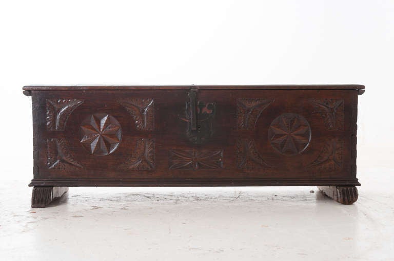 Spanish truck hand carved in the 1700's with forged iron hardware. Wonderful patina!!! Wonderful carving designs, the trunk sits over long bar feet with grooves in the front. Check our extensive website for more trunks and antiques at