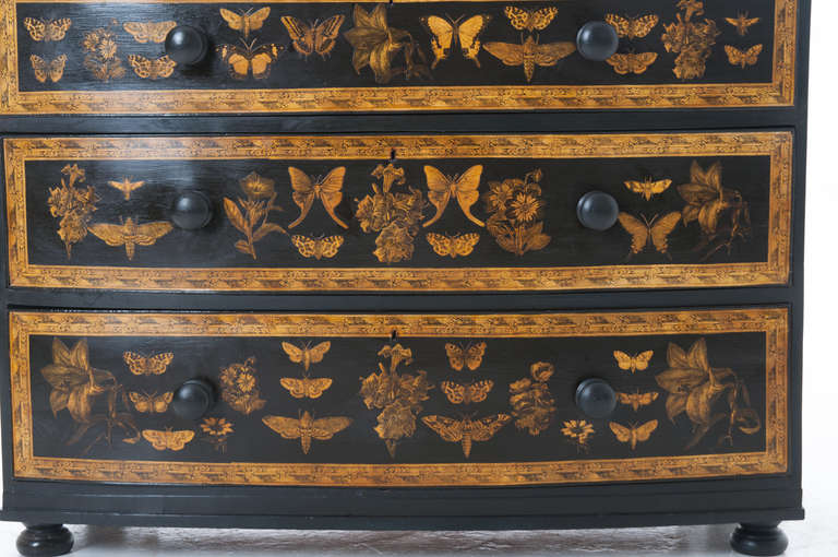 English 1890's chest of five drawers, re-finished with black paint overlaid with decoupage of flowers and butterfly with an interesting boarder.