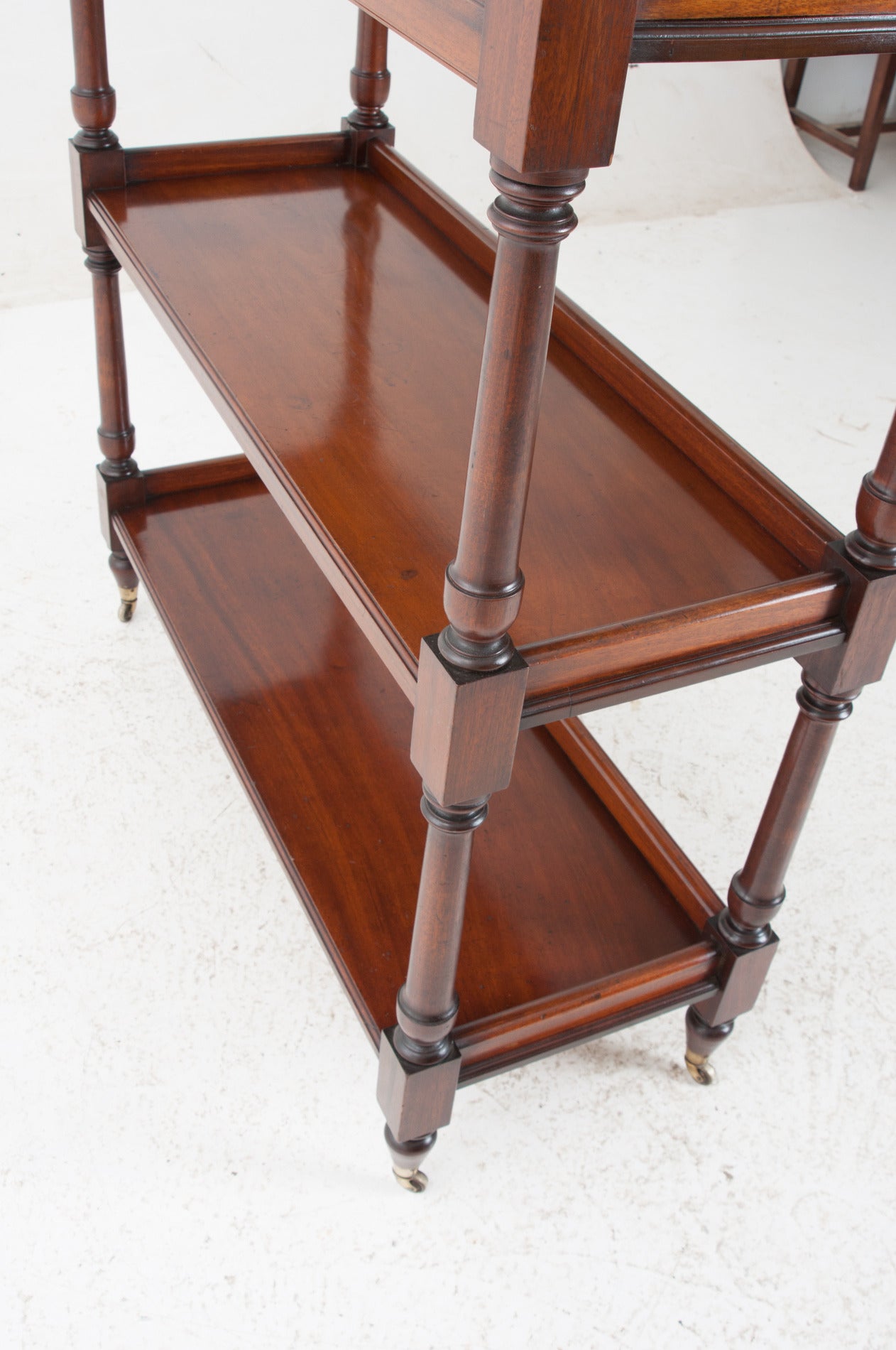 A gorgeous, simply carved mahogany trolley for serving food, drinks or stacking your collectibles. We love how versatile this antique is! This trolley retains its beautiful, rich, original color and patina and has a fresh French polish. 1850