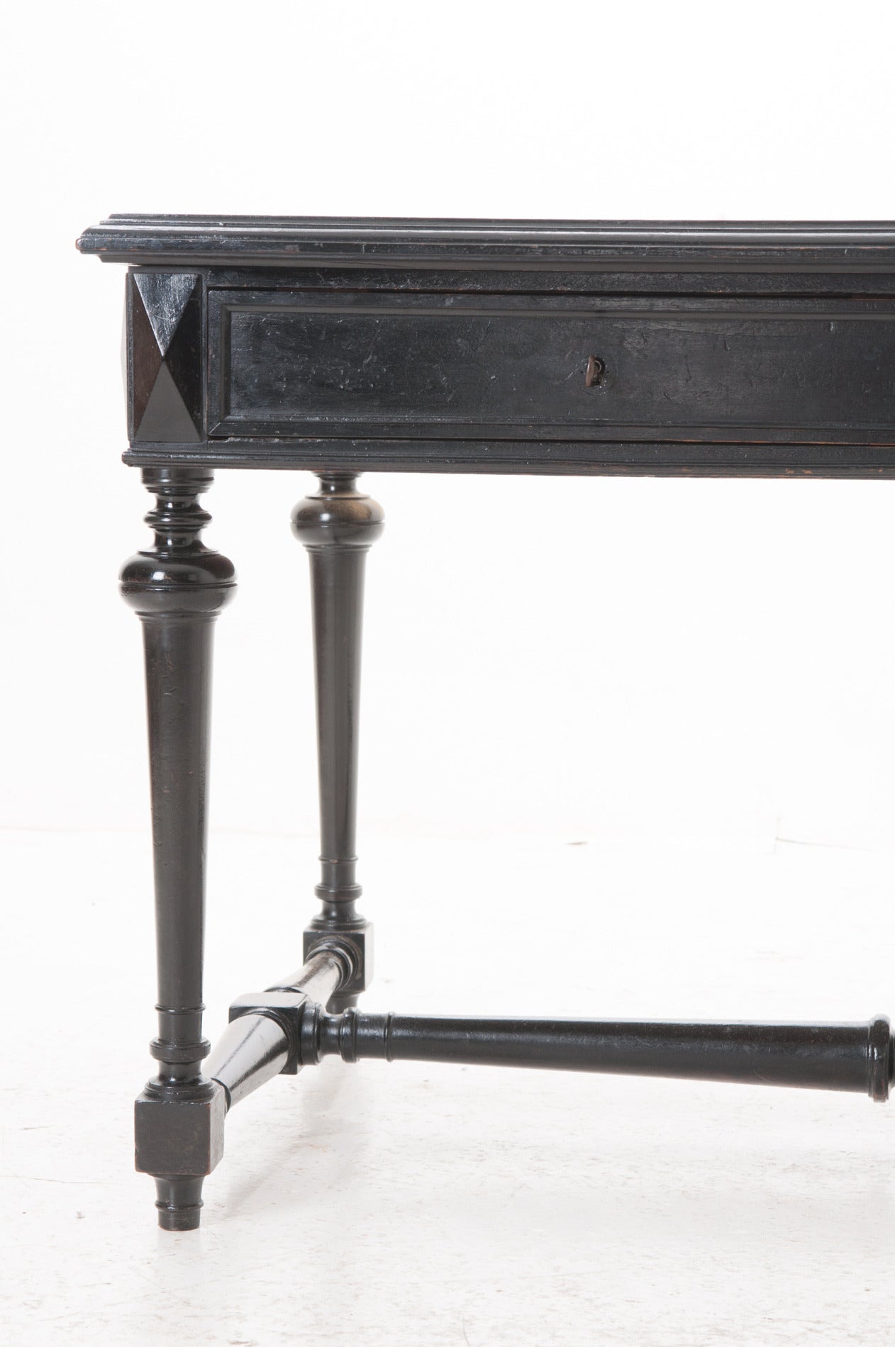 A handsome writing desk of generous size is in great, antique condition. Black leather top is inset with gold trimmings, see the detail photos. There are some marks on the leather but nothing that we would worry about! The apron of this desk if